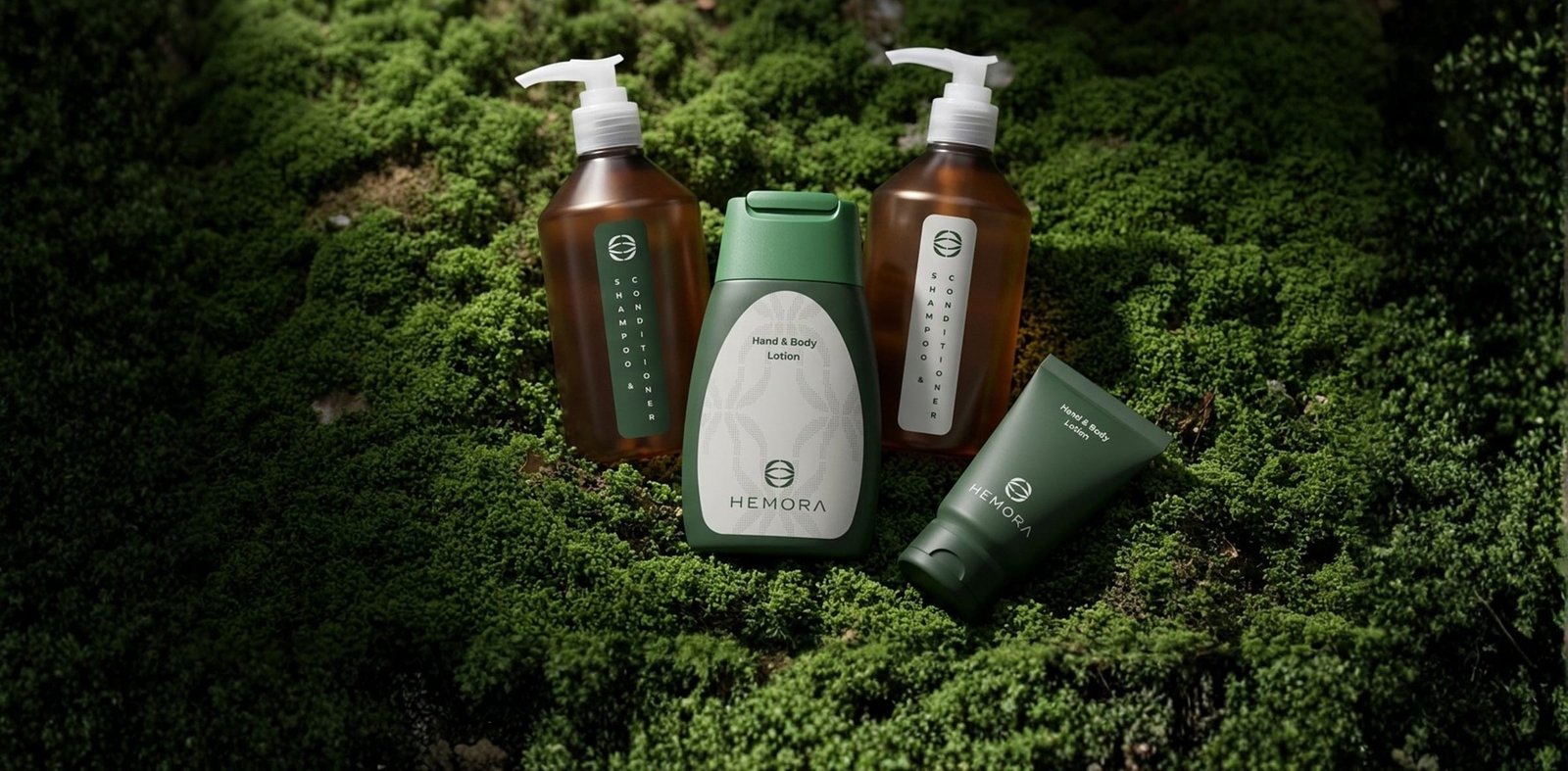 Hemora guest amenity bottles on moss