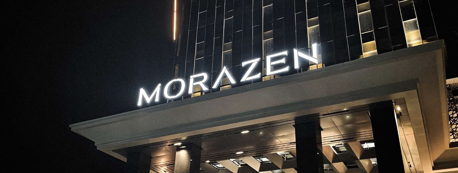 Morazen hotel facade signage at night